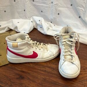 White high top Nike sneakers with hot pink swoosh